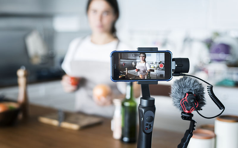 vlogger recording cooking programme for social media